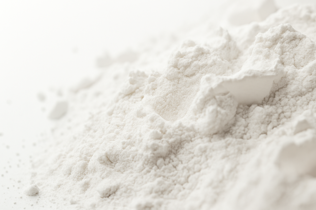 A close-up of fine magnesium powder on a beige background, representing the best magnesium for sleep.