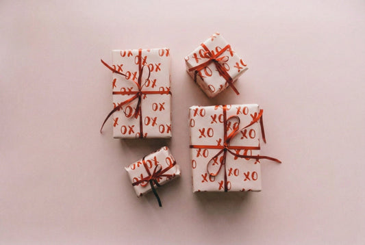 Four gifts wrapped in pink wrapping paper.